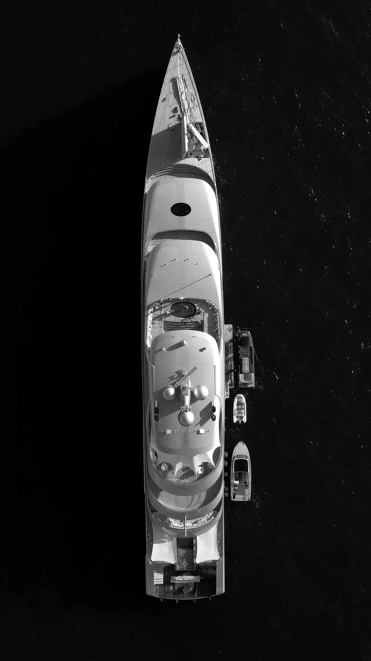 A superyacht seen from directly above on black water