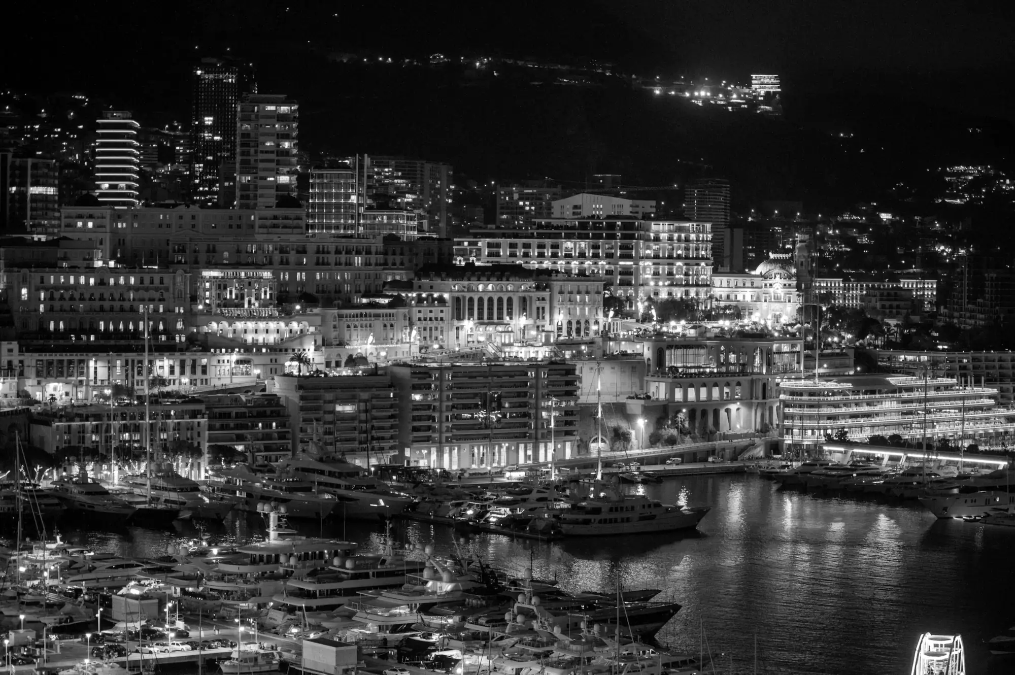 Superyachts berthed in Monaco harbour at night
